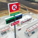 aerial photos of circle k pylon with building and pumps in the background